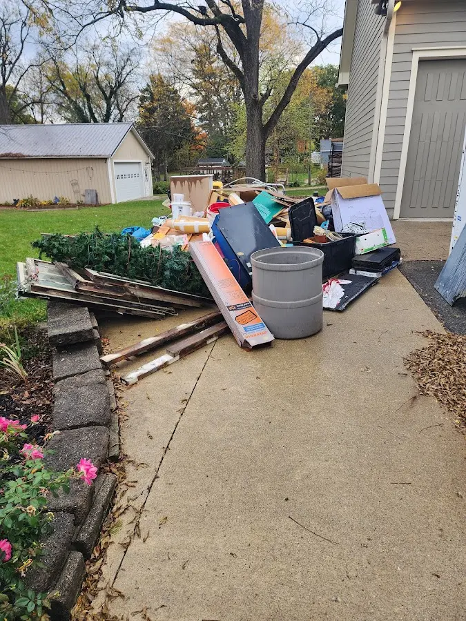 Dumpster being loaded with debris for Estate Cleanout Dumpster Rental in North Ogden